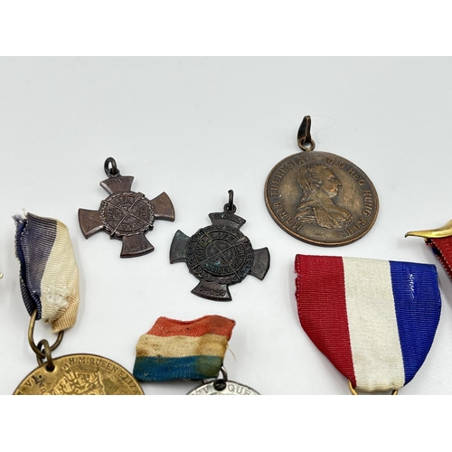 2120 - A collection of medals and badges to include King George VI and Queen Elizabeth 1937 Coronation meda... 