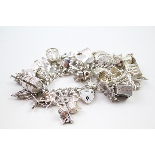 2331 - A silver charm bracelet with novelty charms - approx. gross weight 141g