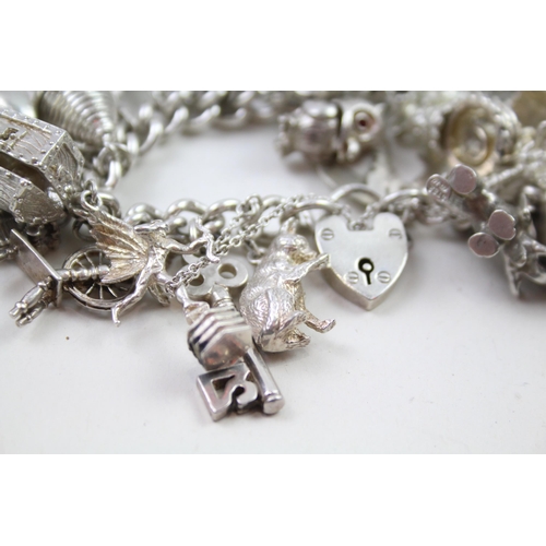 2331 - A silver charm bracelet with novelty charms - approx. gross weight 141g