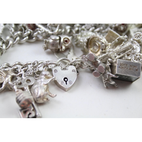 2331 - A silver charm bracelet with novelty charms - approx. gross weight 141g