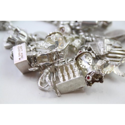 2331 - A silver charm bracelet with novelty charms - approx. gross weight 141g