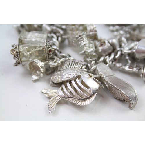 2331 - A silver charm bracelet with novelty charms - approx. gross weight 141g