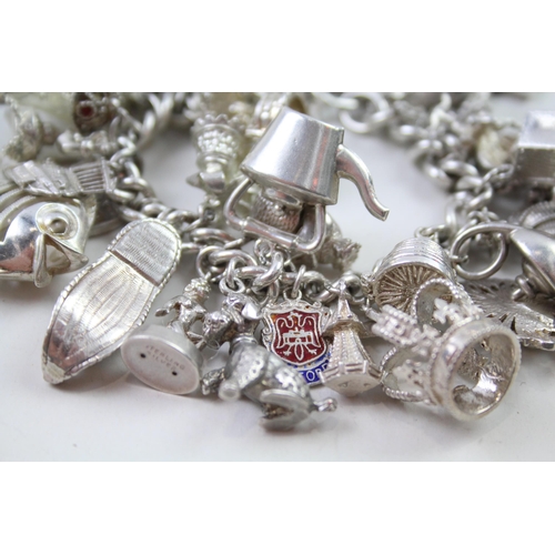 2331 - A silver charm bracelet with novelty charms - approx. gross weight 141g