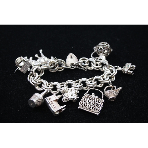 2335 - A silver charm bracelet with novelty charms - approx. gross weight 106g