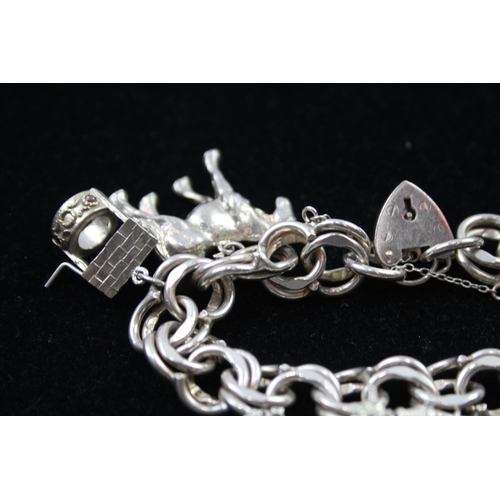 2335 - A silver charm bracelet with novelty charms - approx. gross weight 106g