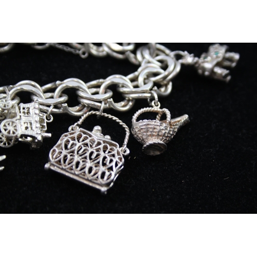 2335 - A silver charm bracelet with novelty charms - approx. gross weight 106g