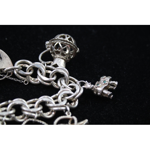 2335 - A silver charm bracelet with novelty charms - approx. gross weight 106g