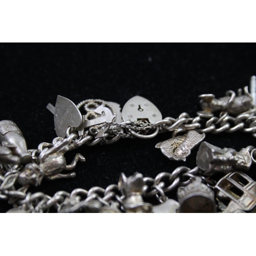 2335A - A silver charm bracelet with novelty charms - approx. gross weight 86g