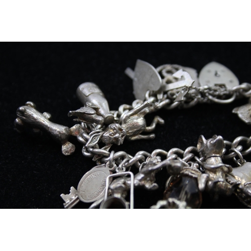 2335A - A silver charm bracelet with novelty charms - approx. gross weight 86g