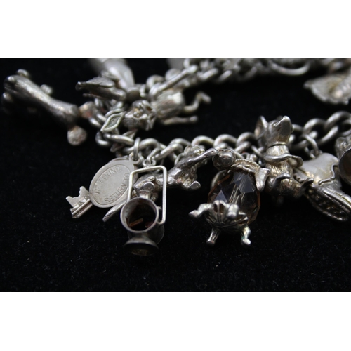 2335A - A silver charm bracelet with novelty charms - approx. gross weight 86g