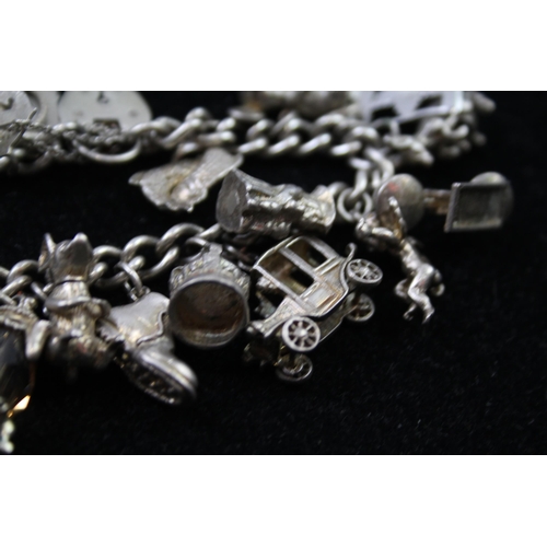 2335A - A silver charm bracelet with novelty charms - approx. gross weight 86g