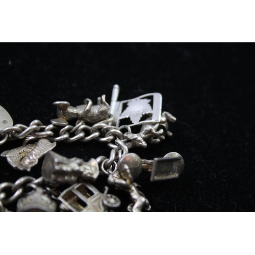 2335A - A silver charm bracelet with novelty charms - approx. gross weight 86g