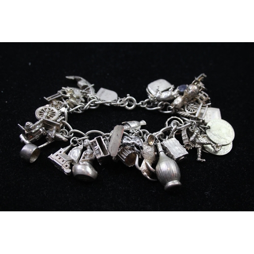 2336 - A silver charm bracelet with novelty charms - approx. gross weight 116g