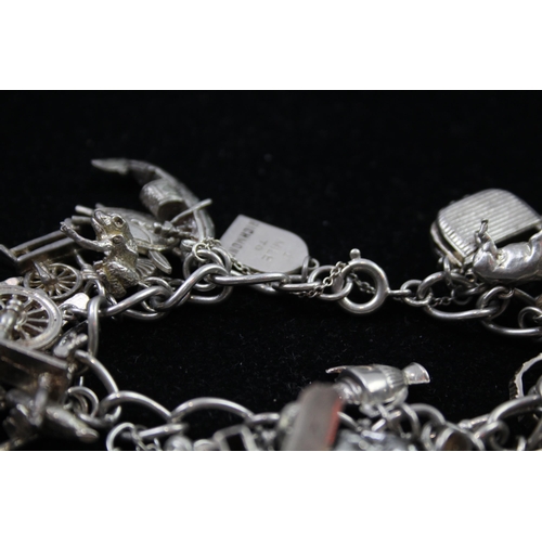 2336 - A silver charm bracelet with novelty charms - approx. gross weight 116g