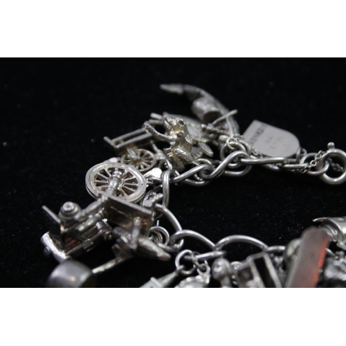 2336 - A silver charm bracelet with novelty charms - approx. gross weight 116g