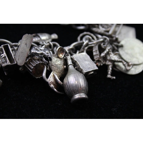 2336 - A silver charm bracelet with novelty charms - approx. gross weight 116g