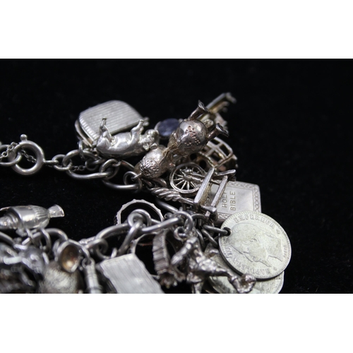 2336 - A silver charm bracelet with novelty charms - approx. gross weight 116g