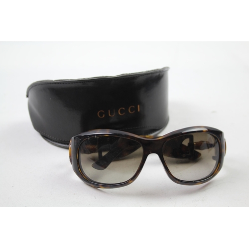 617 - A cased pair of Gucci sunglasses