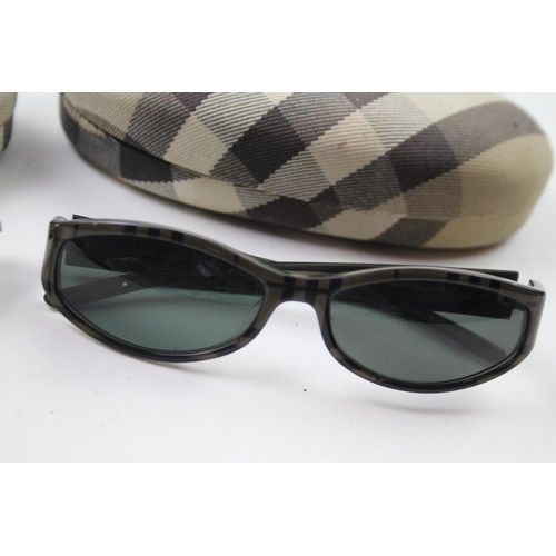 627 - Two pairs of cased Burberry sunglasses