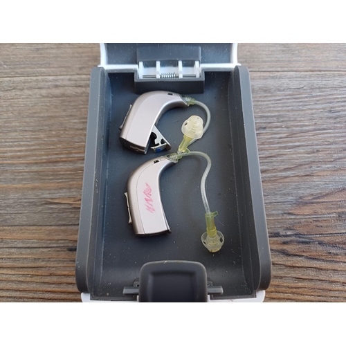 845 - A cased pair of Oticon Spirit Synergy hearing aids