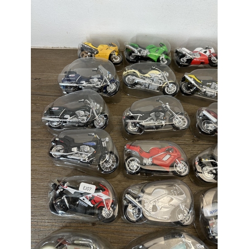 302 - A collection of packaged die-cast model motorcycles to include Harley Davidson, Yamaha, Police, Kawa... 