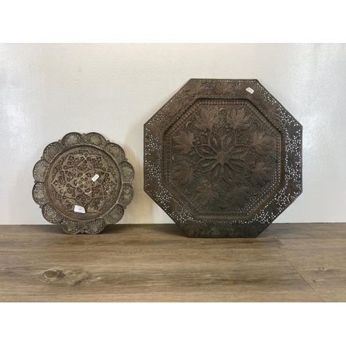 529 - Two Middle Eastern pierced and engraved copper wall chargers - largest approx. 51cm high