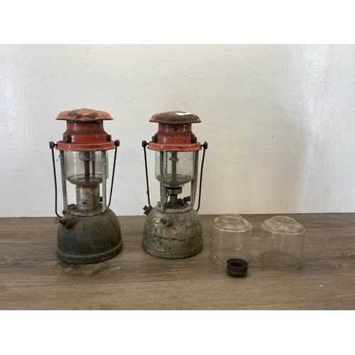 535 - Two mid 20th century red enamel and metal paraffin lanterns