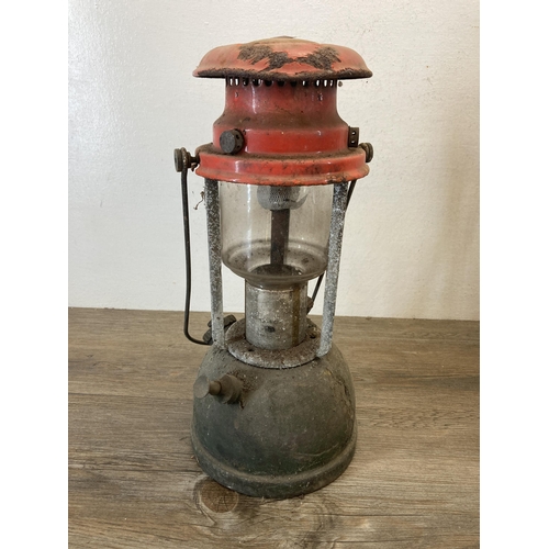 535 - Two mid 20th century red enamel and metal paraffin lanterns