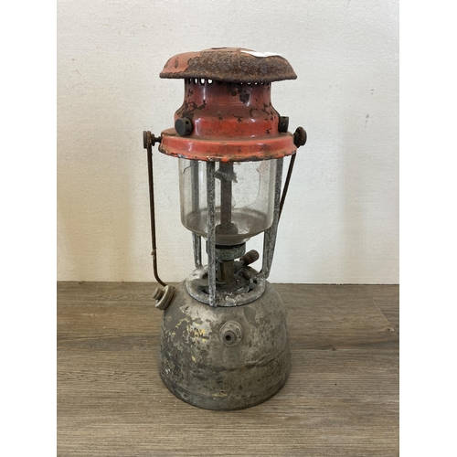 535 - Two mid 20th century red enamel and metal paraffin lanterns