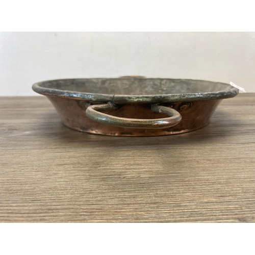 547 - A 19th century copper two handled cooking pan - approx. 31cm diameter