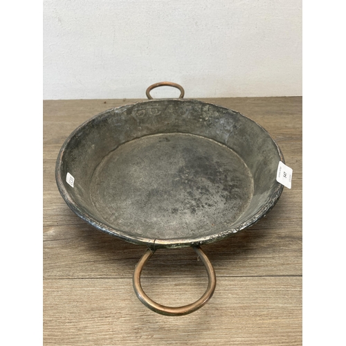 547 - A 19th century copper two handled cooking pan - approx. 31cm diameter