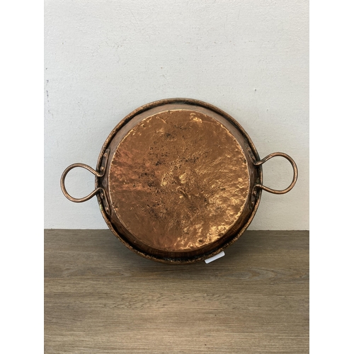 547 - A 19th century copper two handled cooking pan - approx. 31cm diameter