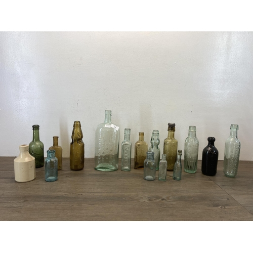 563 - A collection of vintage glass and stoneware bottles to include Parkinson Macclesfield, Thompson Mitc... 