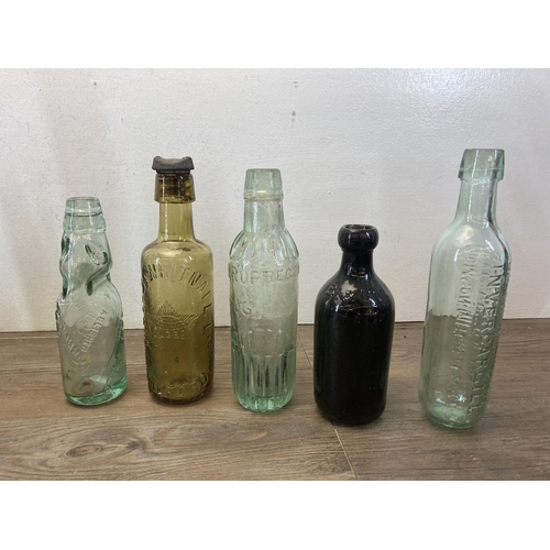 563 - A collection of vintage glass and stoneware bottles to include Parkinson Macclesfield, Thompson Mitc... 