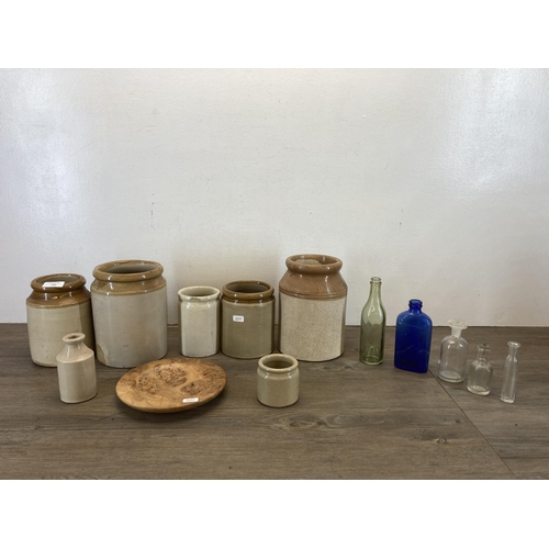 566 - A collection of vintage stoneware and glass bottles and jars together with an AB Dab Design burr oak... 