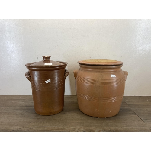 567 - Two salt glazed stoneware twin handled lidded jars - largest approx. 29cm high x 26cm diameter