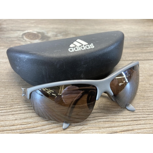 616 - Four pairs of men's sunglasses, one Ray Ban, one Revo, one Maui and one Adidas