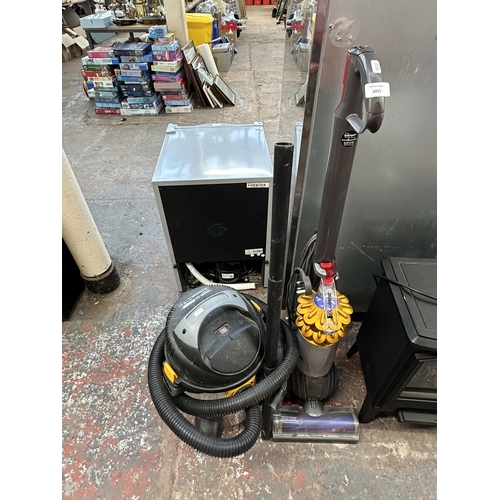 1015 - Two vacuum cleaners, one Dyson DL50 upright bagless and one Titan wet and dry