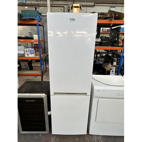 1031 - A Beko CSG1571W upright fridge freezer - approx. 171cm high