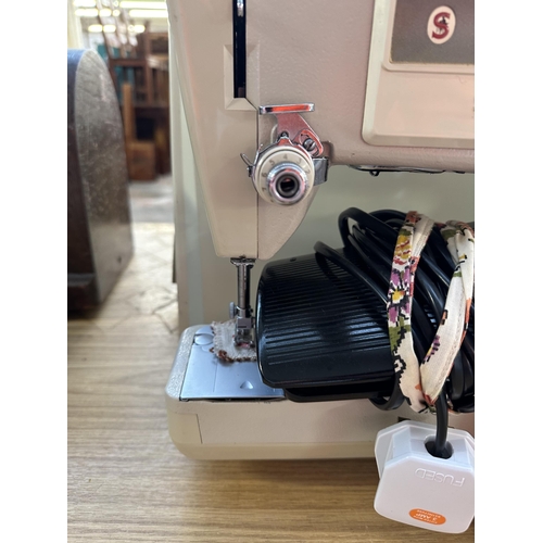 988 - A cased Singer 533 electric sewing machine with foot pedal