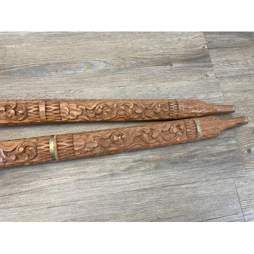 790 - A pair of Middle Eastern decorative tourist swords with carved hardwood handles and sheaths