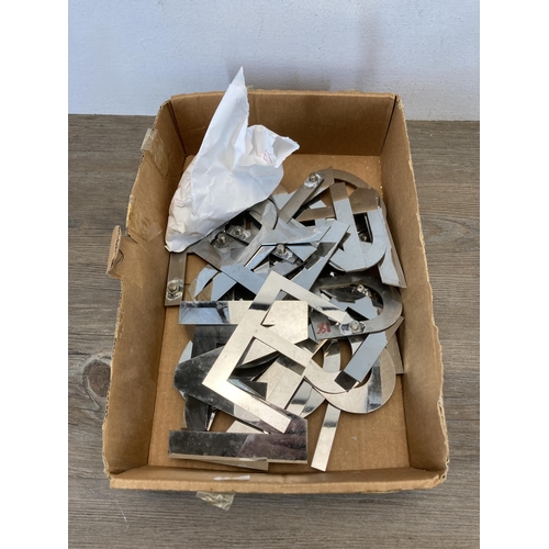 793 - A large collection of aluminium shop letters - largest approx. 12cm high x 13.5cm wide