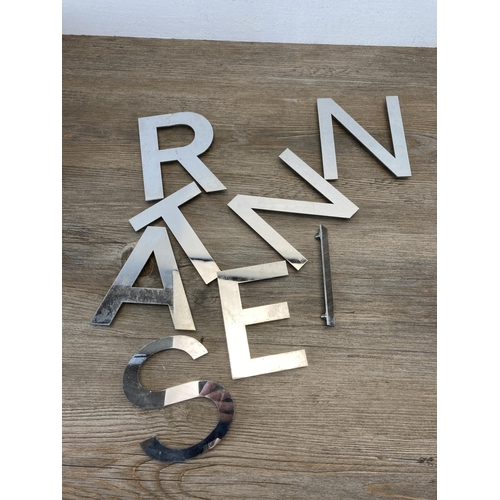 793 - A large collection of aluminium shop letters - largest approx. 12cm high x 13.5cm wide