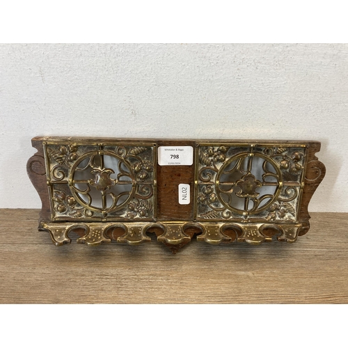 798 - An early/mid 20th century oak and brass six section wall hanging pipe rack - approx. 33cm wide x 14c... 