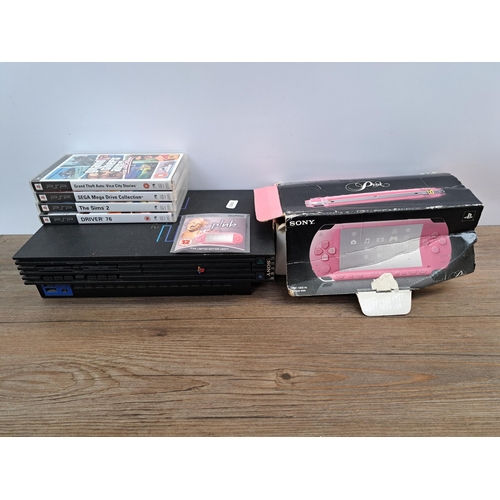 944 - A Sony PlayStation Portable Pink edition box with P!nk UMD Video and four UMD games, Sega Mega Drive... 