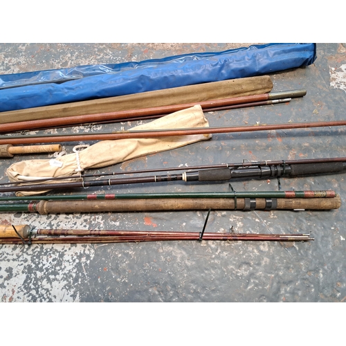 1045 - A collection of vintage fishing rods to include split cane etc.