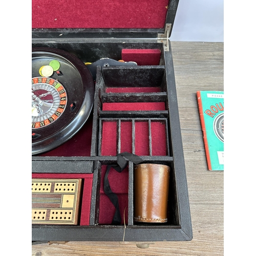 504 - A mid 20th century cased Roulette Wheel and accessories believed to be by K & C London