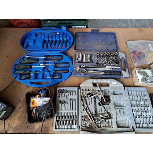 1054 - A large collection of boxed tool sets to include sockets, drill bits, screwdrivers etc.