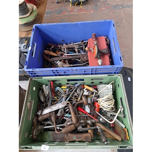 1083 - Two boxes containing a large collection of tools to include pipe wrenches, vintage hand drills, span... 