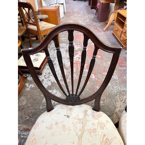 94 - Four 19th century mahogany shield back dining chairs